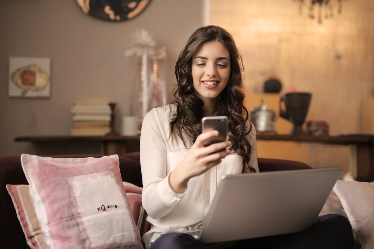 Member smiling at SMS notifications on her phone
